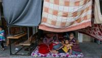 مواطن فلسطيني مع طفله في احد مخيمات النازحين