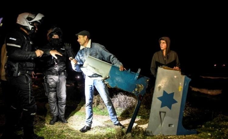 أشخاص يحملون بقايا حطام الطائرة