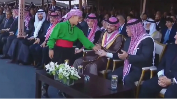 طفل يسلم ورقة لملك الأردن