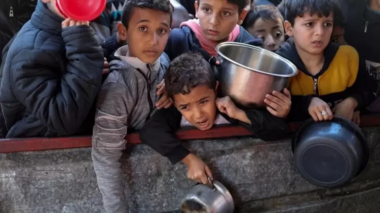 أطفال فلسطينيون ينتظرون الحصول على الطعام وسط نقص الإمدادات الغذائية، مع استمرار الحرب بين حماس وإسرائيل. رفح، جنوب قطاع غزة في 5 فبراير 2024. © رويتر